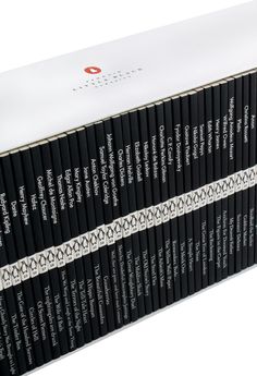 a stack of black and white books sitting on top of each other in front of a white background