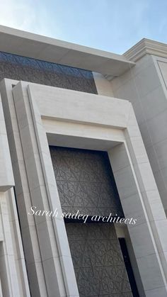 a large white building with an intricate design on it's front door and windows