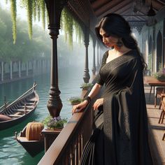 a woman in a black dress standing on a balcony next to a river and boats