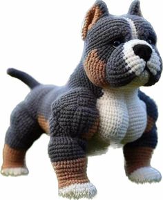 a crocheted dog is standing in the grass