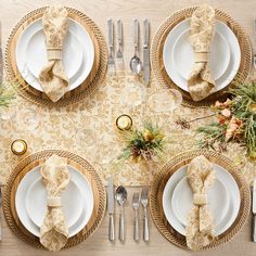 the table is set with place settings, silverware and napkins for christmas dinner