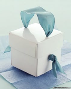 a white box with a blue ribbon tied around it