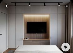 a bedroom with white walls and wooden flooring