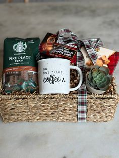 a coffee mug sitting on top of a wicker basket filled with coffee and snacks