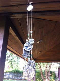 a clock hanging from the side of a wooden structure