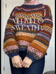 a woman wearing a colorful sweater with her hands in her pockets and the words, veino sweater knitted