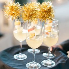 four glasses filled with champagne on top of a table