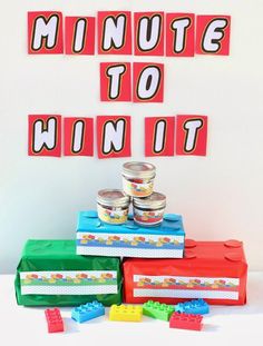 a table topped with lots of lego blocks and containers filled with food next to each other