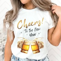 a woman wearing a white shirt with cheers to the new year written on it and two mugs of beer