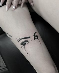 a woman's leg with an eye tattoo on it