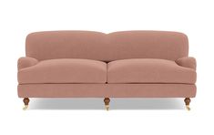 a pink couch sitting on top of a white floor