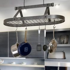 pots and pans hanging from a rack in a kitchen