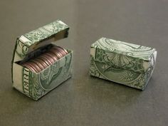 two stacks of money sitting next to each other on top of a table with one rolled up