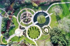 an aerial view of a circular garden in the middle of a park