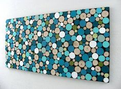 a painting on the wall with blue and green circles painted on it's sides