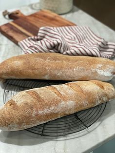 two loaves of bread on a cooling rack