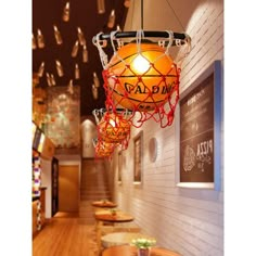 a restaurant with wooden tables and lights hanging from the ceiling