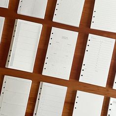 several notebooks lined up on a wooden table