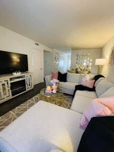 a living room filled with furniture and a flat screen tv