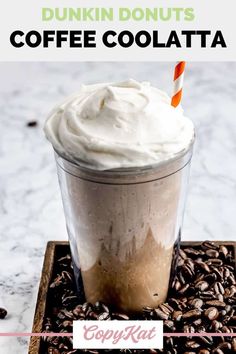 a drink with whipped cream and coffee beans