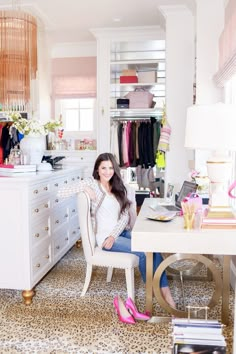 a woman sitting in a chair next to a desk