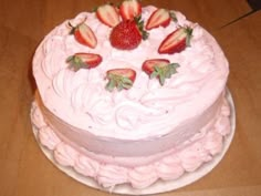 there is a cake that has strawberries on it