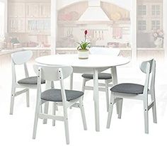 a white table with four chairs around it