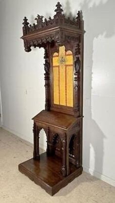 an old wooden grandfather clock sitting on top of a shelf next to a white wall