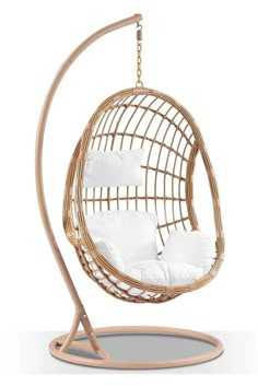 a hanging chair with white pillows on it