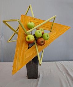 a star shaped vase with apples in it