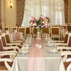 a dining room with tables and chairs set up for a formal function