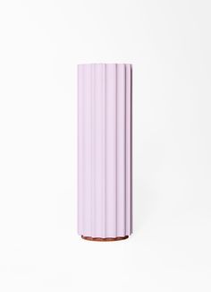 a pink vase sitting on top of a white table