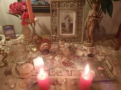 a table with candles and pictures on it