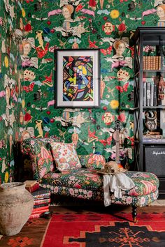 a living room filled with furniture and colorful wallpaper