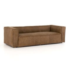 a brown couch sitting on top of a white floor