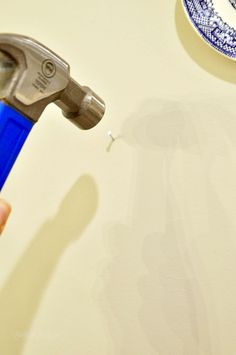 a blue and white plate sitting on top of a table next to a wrench