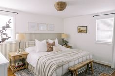 a bedroom with white walls and wooden floors