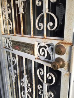 an old iron door with some knobs on it