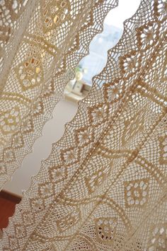 a close up view of a lace curtain