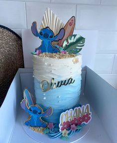 there is a blue cake with white frosting on the top and some decorations around it