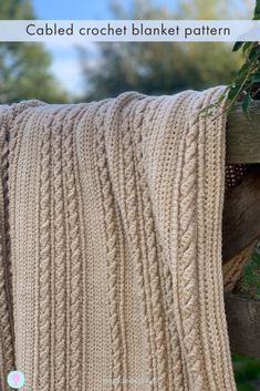 a blanket is hanging on the side of a wooden fence