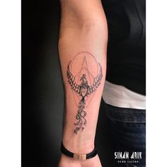 a woman's arm with a tattoo on it and an arrow in the middle