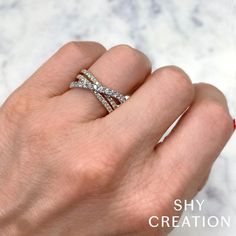 a woman's hand with a diamond ring on top of her finger and the words shy creation written below it