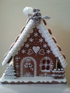 a gingerbread house decorated with icing and snowflakes