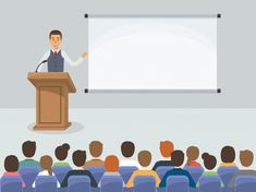 a man standing at a podium in front of an audience with a white board behind him