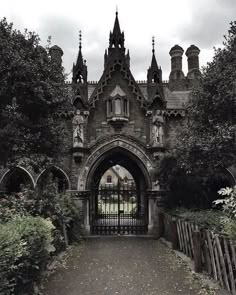 an old building with a gate and clock tower on it's front entrance way