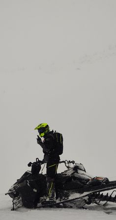 a man on a snowmobile in the snow