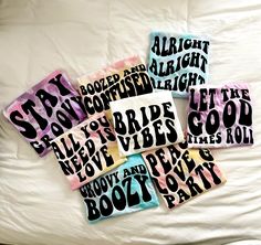 six stickers with words on them sitting on a bed