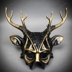 Mystery And Allure With Our Antler Deer Textured Horn With Brushed Gold Laces Devil Halloween Masquerade Mask In Black. Perfect For Anyone Seeking An Unforgettable Halloween Costume Or Masquerade Accessory, This Mask Combines The Wild Elegance Of Antler Deer Horns With The Mysterious Charm Of A Masquerade. Crafted From Durable Plastic, The Mask Features A Textured Design That Mimics The Aged Look Of Antique Artifacts, Painted In A Popcorn Textured Black To Enhance Its Appeal. Measuring Approxima Steampunk Halloween Party Masks, Horned Masquerade Mask For Halloween, Punk Masquerade Mask For Halloween Party, Punk Style Masquerade Mask For Halloween Party, Fantasy Horned Masks And Prosthetics For Party, Punk Style Halloween Masquerade Mask For Party, Horned Masks And Prosthetics For Halloween Party, Halloween Party Horned Masks And Prosthetics, Horned Masquerade Mask For Halloween Costume Party