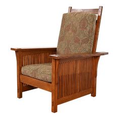 a wooden chair with a patterned upholstered back and arm rests against a white background